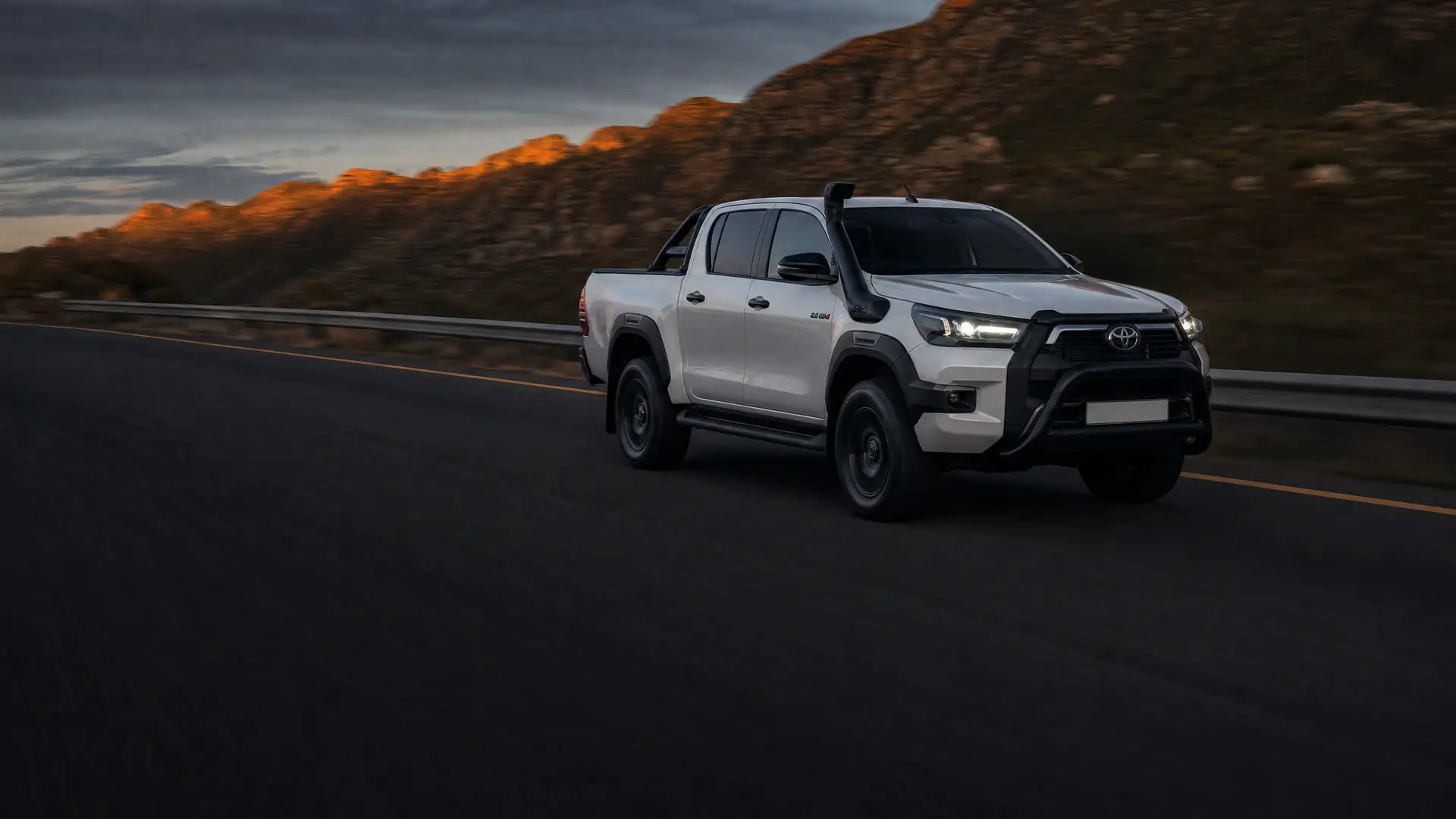 Toyota Hilux Legend RS bakkie on a Western Cape mountain pass at dusk, from Cars342, used car dealer in Bellville